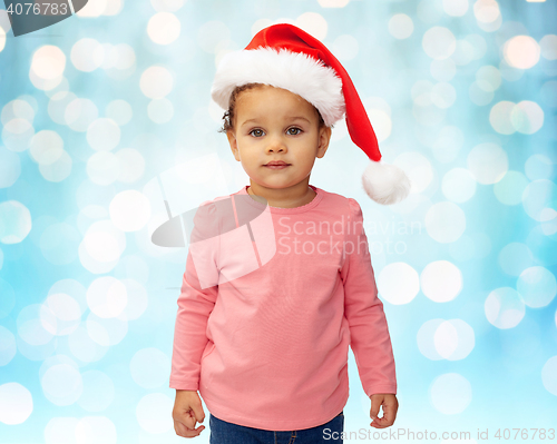 Image of beautiful little baby girl in christmas santa hat