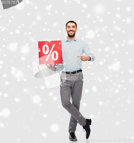 Image of smiling man with red percentage sign over snow