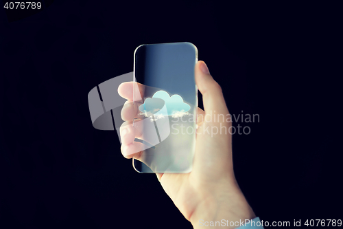 Image of close up of male hand with transparent smartphone