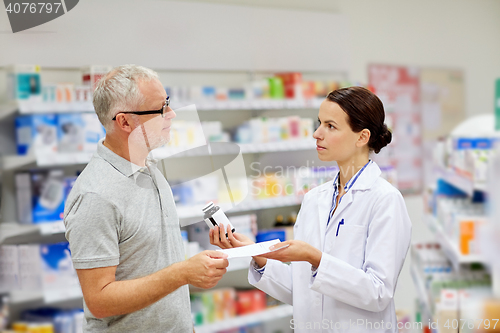 Image of pharmacist and senior man buying drug at pharmacy