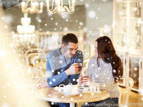 Image of happy couple drinking tea at cafe