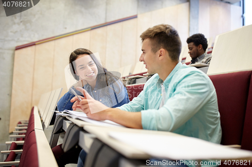 Image of group of students with notebooks at lecture hall