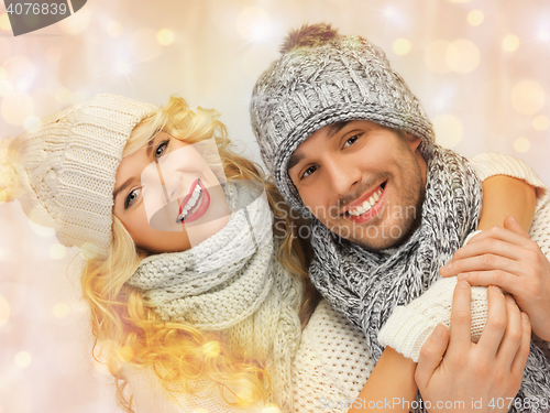 Image of happy family couple in winter clothes hugging