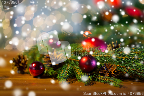 Image of fir branch with christmas ball and pinecones