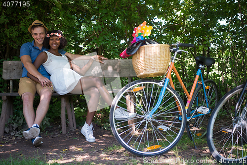 Image of Young multiethnic couple having a bike ride in nature