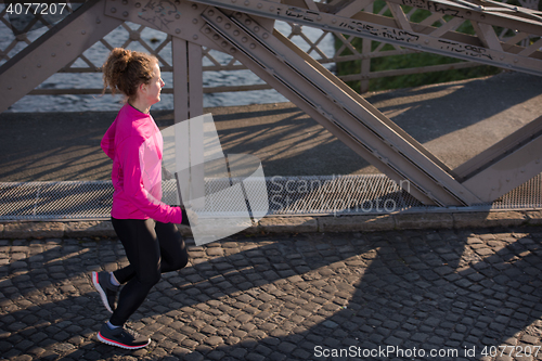 Image of sporty woman jogging on morning