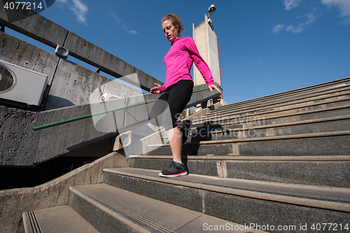 Image of woman jogging on  steps