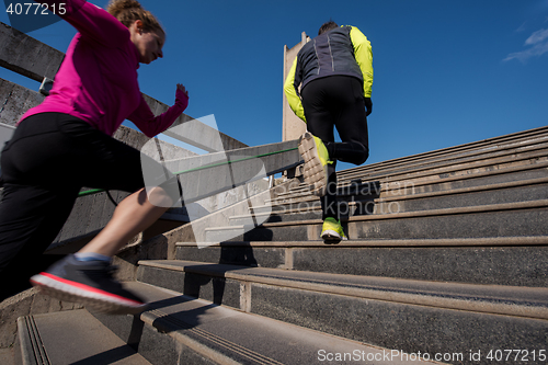 Image of young  couple jogging on steps