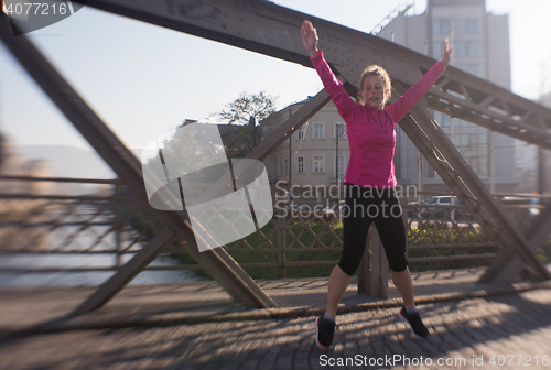Image of woman  stretching before morning jogging