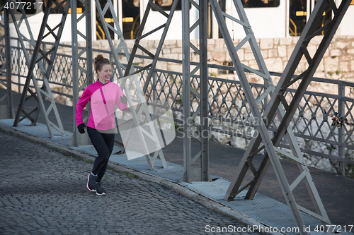 Image of sporty woman jogging on morning