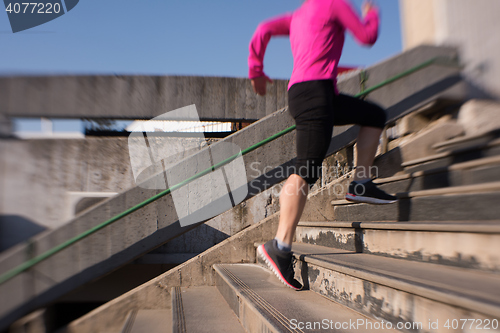 Image of woman jogging on  steps