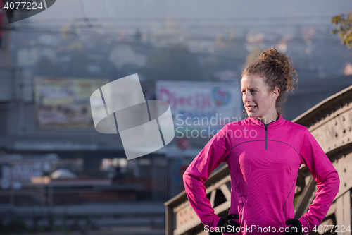 Image of woman  stretching before morning jogging