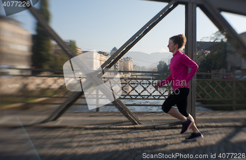 Image of sporty woman jogging on morning