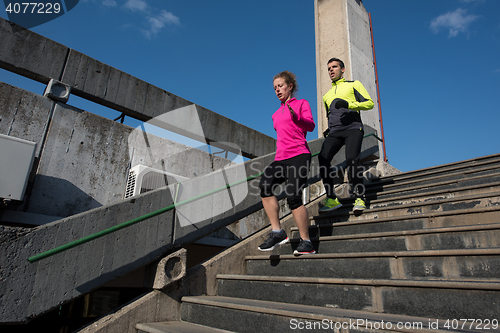 Image of young  couple jogging on steps