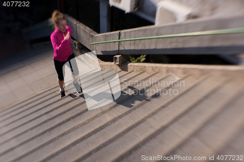 Image of woman jogging on  steps