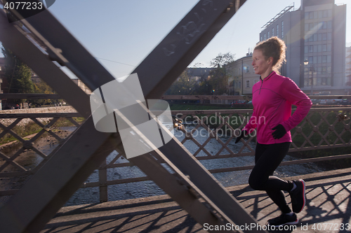 Image of sporty woman jogging on morning