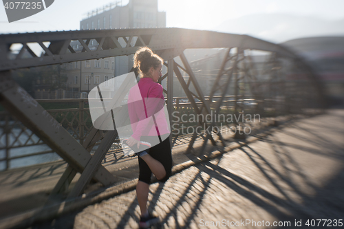 Image of sporty woman jogging on morning