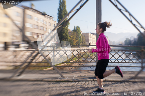 Image of sporty woman jogging on morning