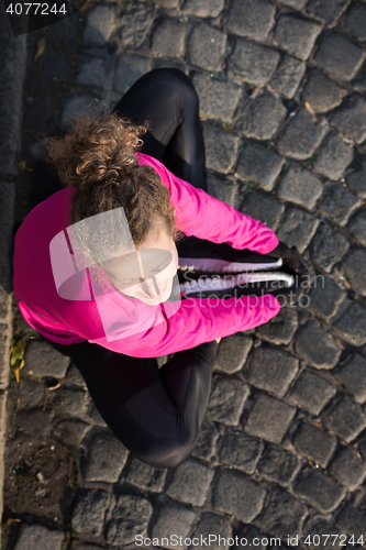 Image of woman  stretching before morning jogging