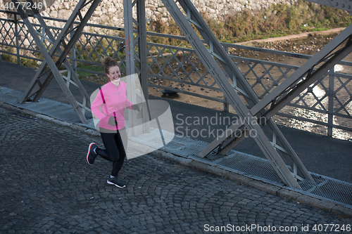 Image of sporty woman jogging on morning