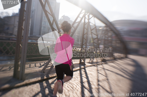 Image of sporty woman jogging on morning