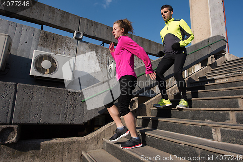 Image of young  couple jogging on steps