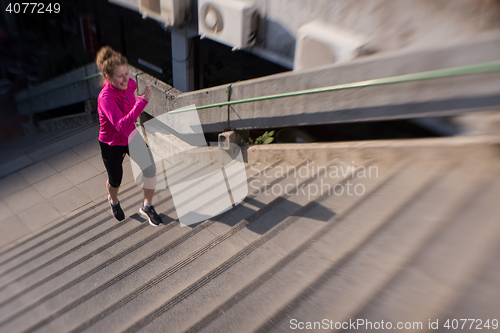 Image of woman jogging on  steps