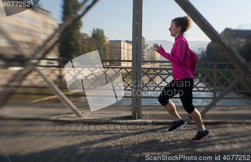 Image of sporty woman jogging on morning