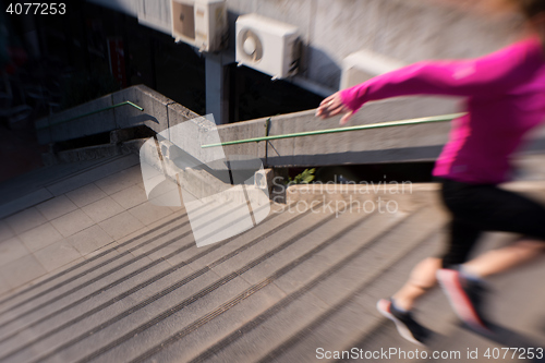 Image of woman jogging on  steps