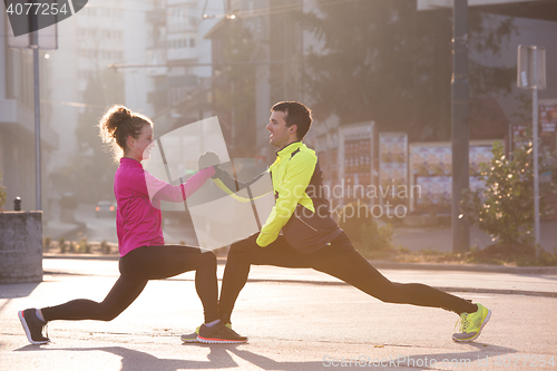 Image of couple warming up before jogging