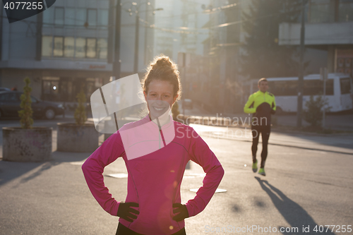 Image of woman  stretching before morning jogging