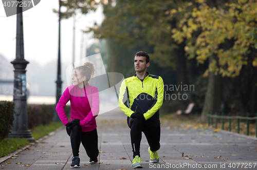 Image of couple warming up before jogging