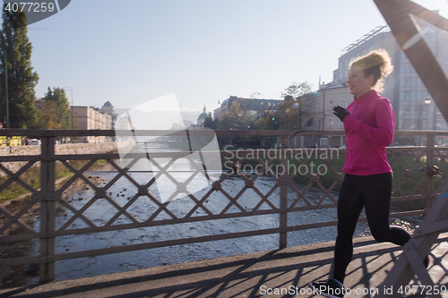 Image of sporty woman jogging on morning