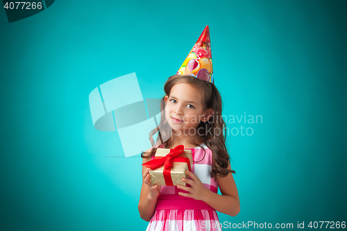 Image of The cute cheerful little girl on blue background