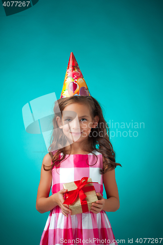 Image of The cute cheerful little girl on blue background