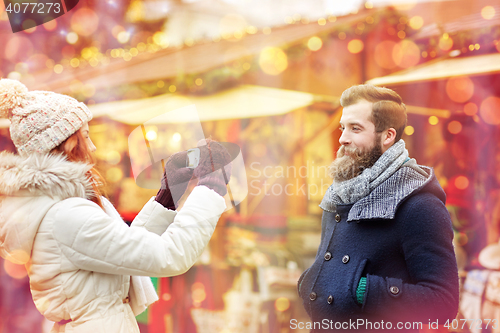 Image of couple taking selfie with smartphone in old town