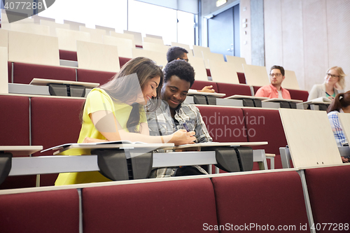 Image of group of students with notebooks at lecture hall