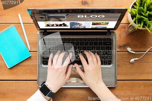 Image of close up of woman blogging on laptop