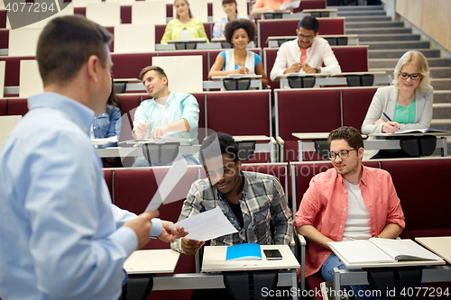 Image of teacher giving tests to students at lecture