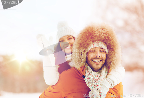 Image of happy couple having fun over winter background