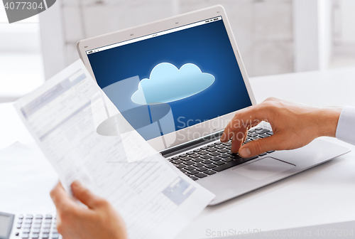 Image of businessman with laptop computer working at office