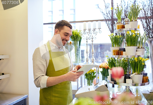 Image of man with tablet pc computer at flower shop