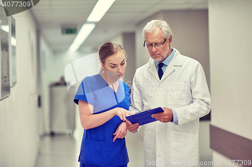 Image of senior doctor and nurse with tablet pc at hospital