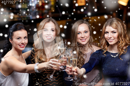 Image of happy women with champagne glasses at night club