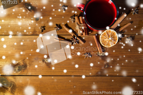 Image of tea cup with winter spices on wooden table