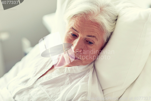 Image of senior woman patient lying in bed at hospital ward