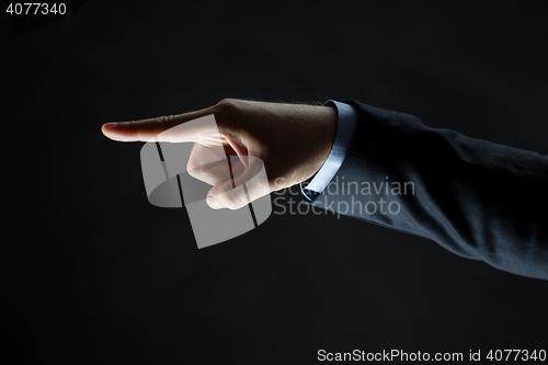 Image of close up of hand pointing finger to something