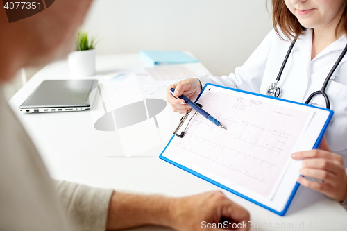 Image of senior man and doctor with cardiogram at hospital