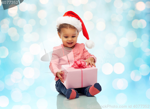 Image of happy little baby girl with christmas present