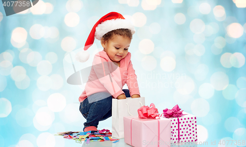 Image of happy little baby girl with christmas presents